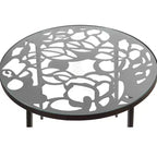LeisureMod Devon 5-Piece Outdoor Dining Set - Round Glass Table with 4 Black Flower Design Stackable Chairs