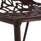 LeisureMod Devon 5-Piece Outdoor Dining Set - Round Glass Table with 4 Black Flower Design Stackable Chairs